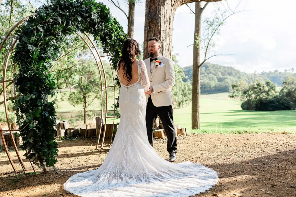 couple standing at the alter at Mystwood Wedding Venue saying their wedding vows 